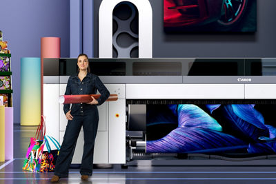 Woman standing in front of a Canon large format printer